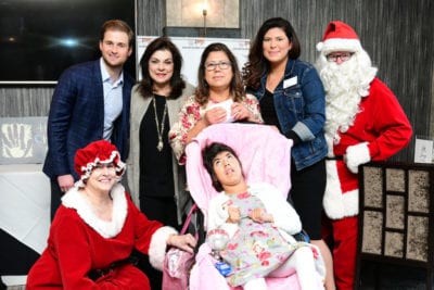 Fertitta Entertainment’s Patrick Fertitta and Houston Children’s Charity President & CEO, Laura Ward, are photographed with the Escobar Family, one of 15 households who received wheelchair-accessible vans last week through the Chariots for Children program.