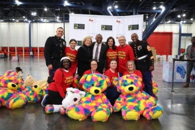 Mayor Sylvester Turner joins HCC President & CEO, Laura Ward, Board Members Edna Meyer-Nelson and Robert Ogle, along with U.S. Marines (including Toys for Tots Coordinator, Gunnery Sergeant Charles Burks – pictured far right) and volunteers Friday morning at the George R. Brown Convention Center. 